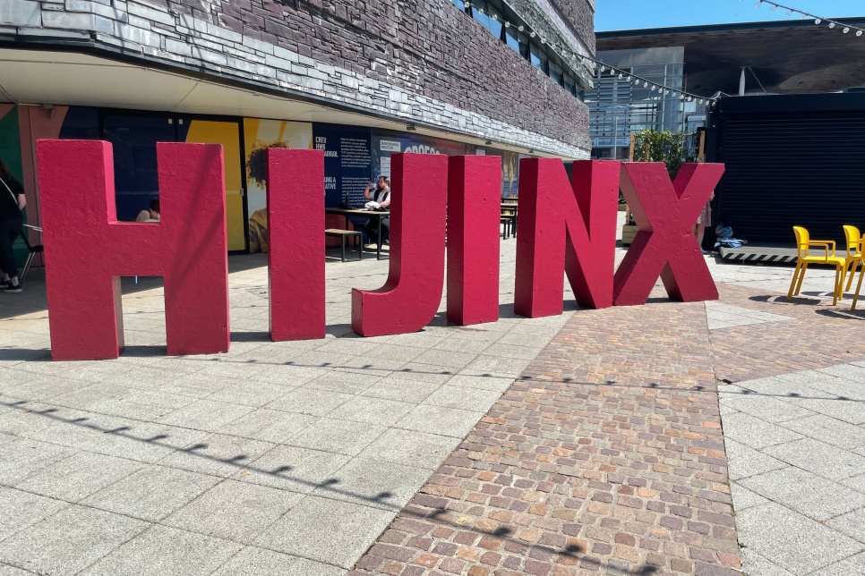 Statues of tall red letters spelling the word HIJINX