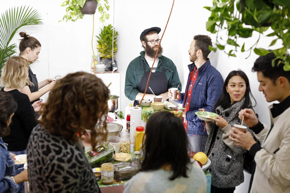 Group of people eating and talking during collaborative project 7 Common by Case Studios