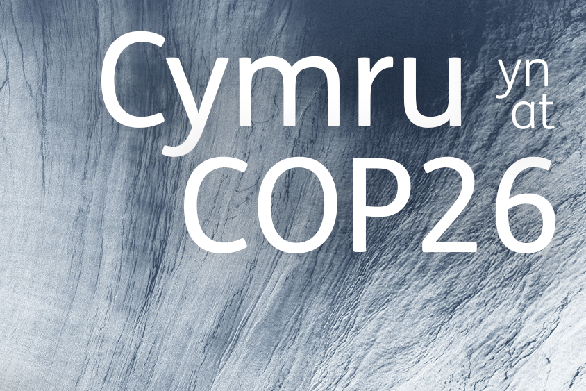 Abstract image of water with 'Cymru at/yn COP26' in white text at the top right, and the Wales Arts International logo bottom left