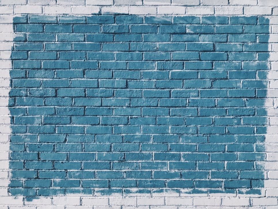Grey bricks with blue square painted on them