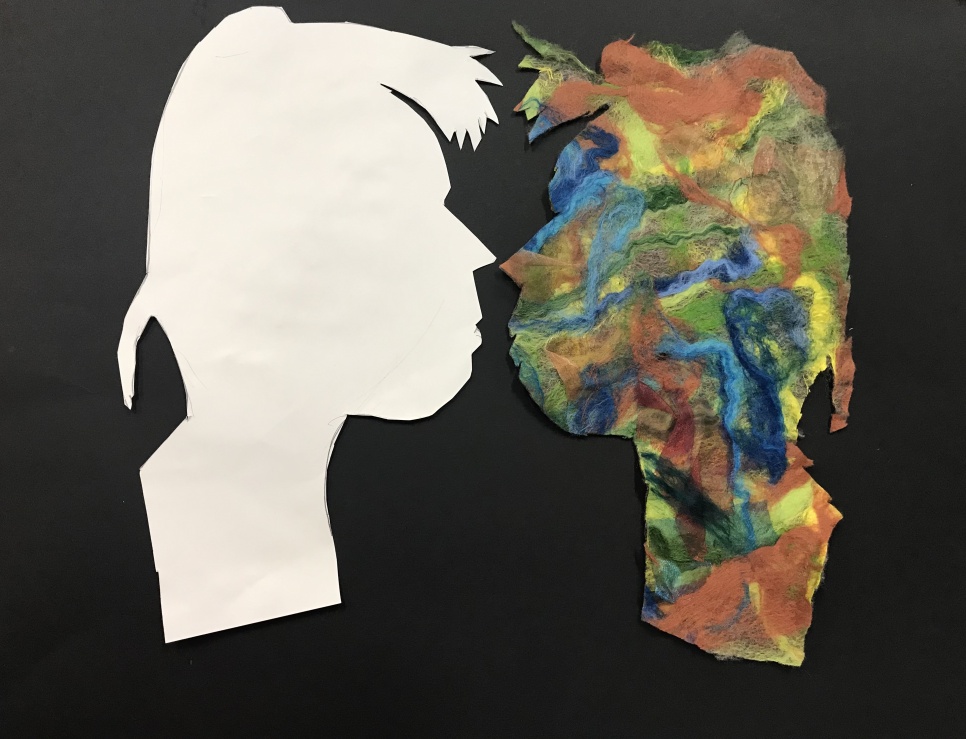 Artwork of two profiles of a head, one all in white and another with colour