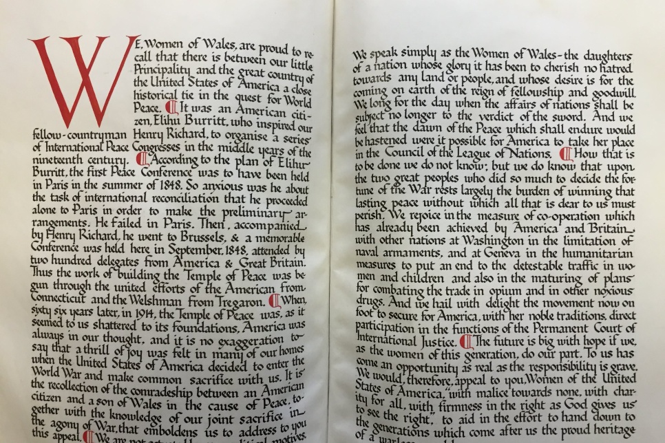 Declaration of the Welsh Women's Peace Appeal to America, 1923-24 A open book with calligraphic writing in red and black.