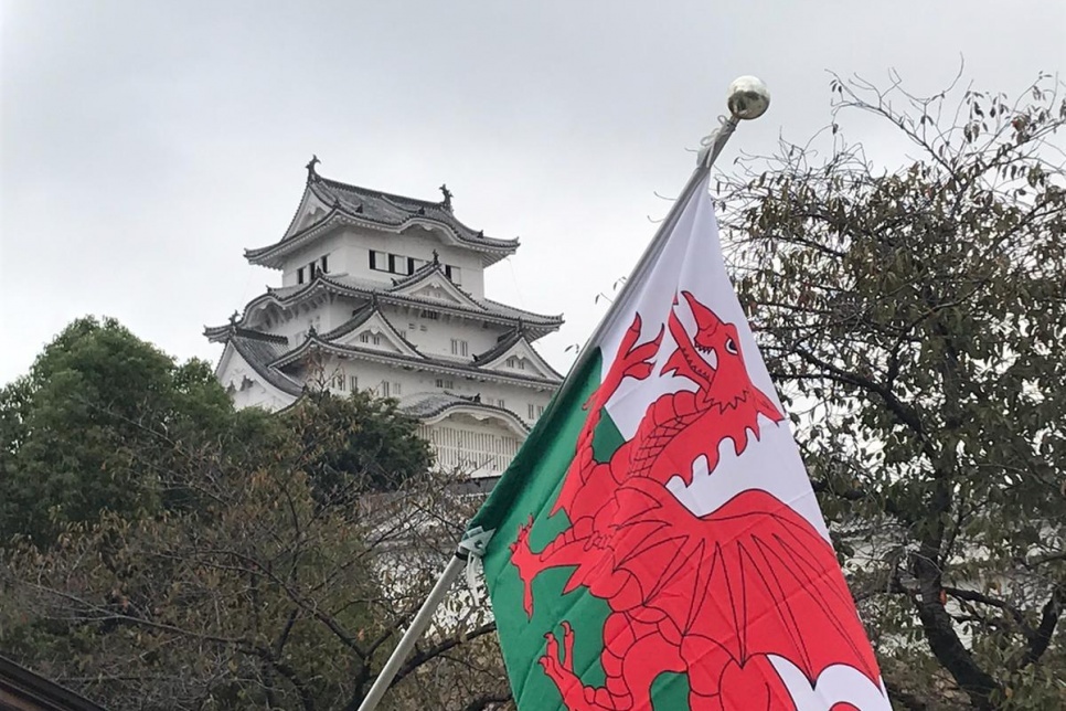 Japanese building with the Welsh flag in front