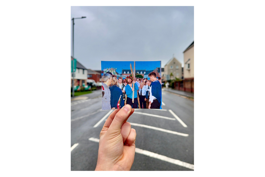 An image of a photo being held against a real-life image of a street with a picture of Michael Sheen from The Passion