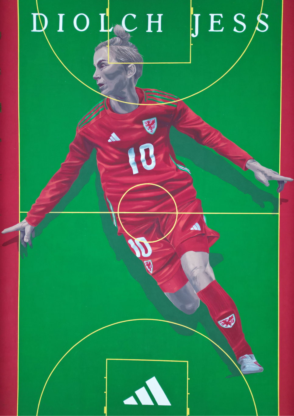 Image of Jess Fishlock in full Welsh kit pained on a pitch