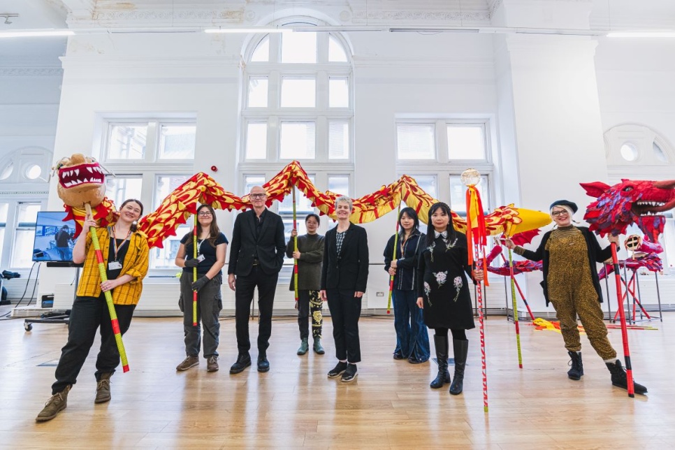Artists holding a chinese dragon in the Old Library