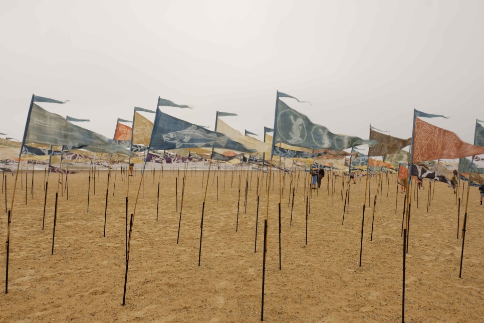 A beach with many small banners