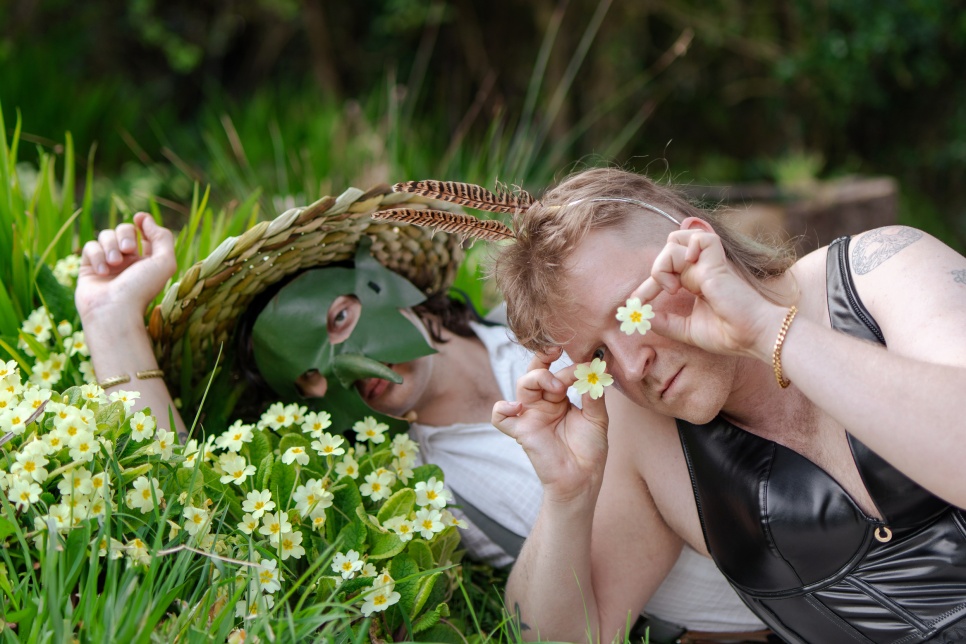 Two people lying on a bed of flowers