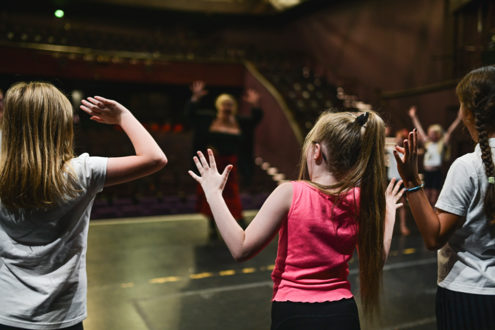 a group of children taking part in a workshop