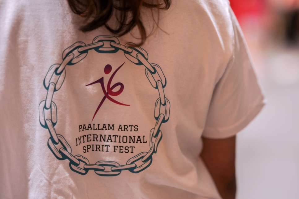 Photograph - Paallam Arts International Festival logo on the back of a t shirt / Ffotograff: Logo Gŵyl Gelfyddydau Rhyngwladol Paallam ar gefn crys-t
