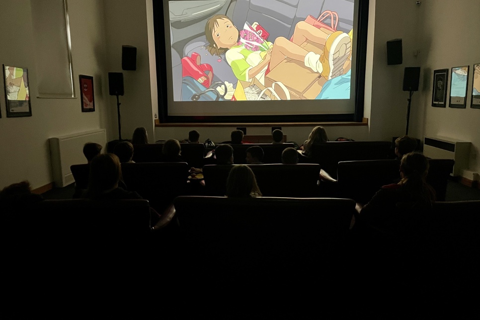 A cinema screen in a dark room