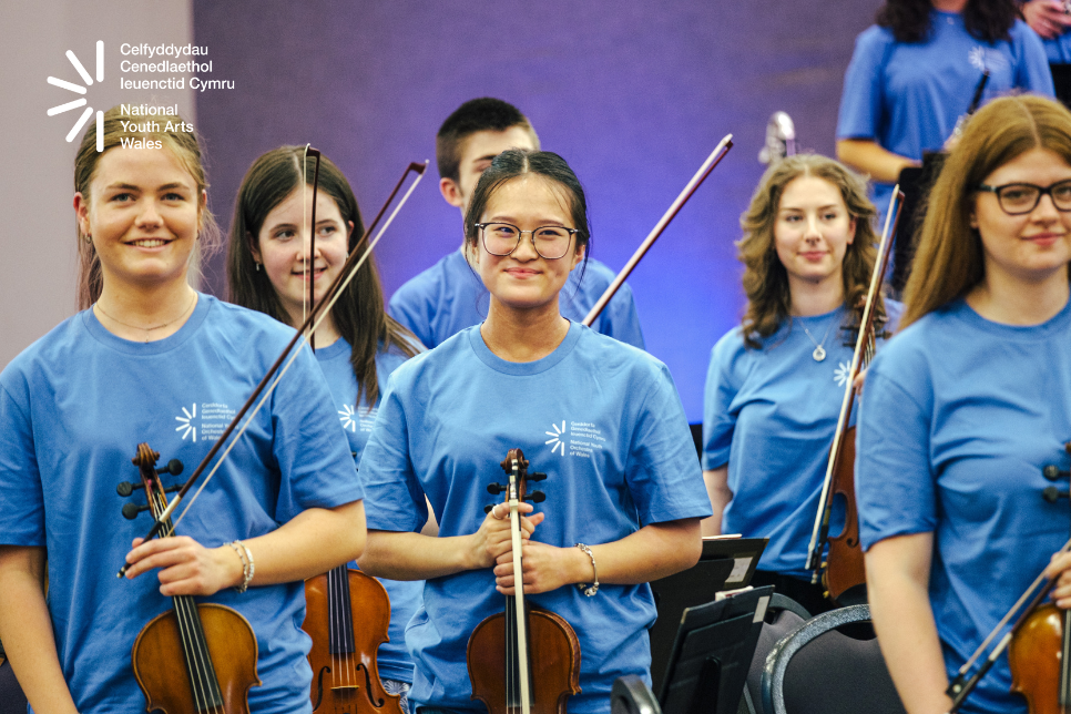 Photograph of young people holding instruments / Ffotograff o bobl ifanc yn dal offerynnau